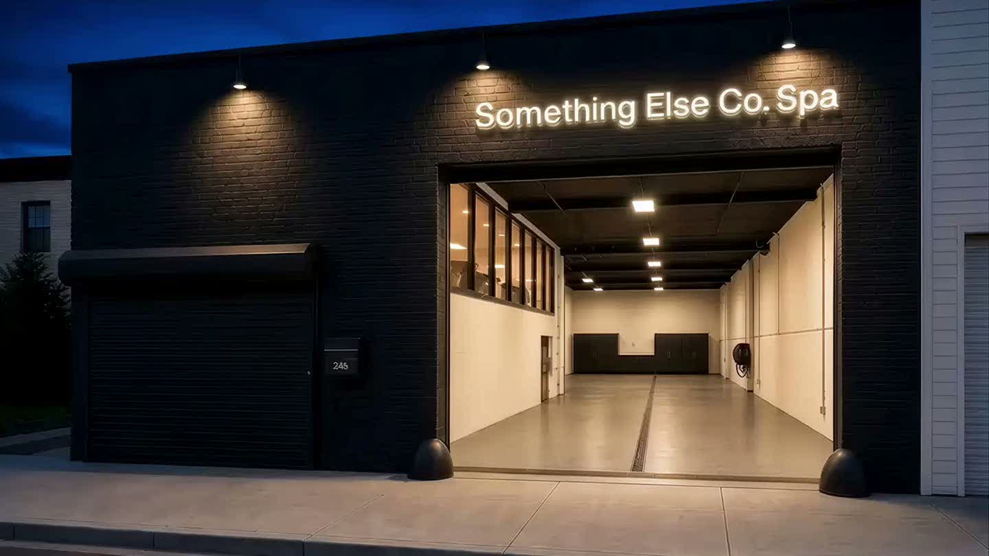 Something Else Co. Spa storefront at dusk, gate open, lit sign