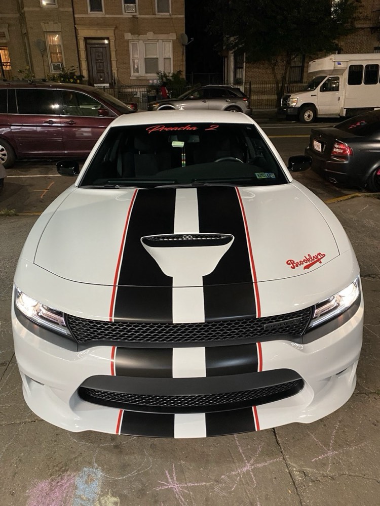 White Dodge Charger with black and red pinstriped racing stripes