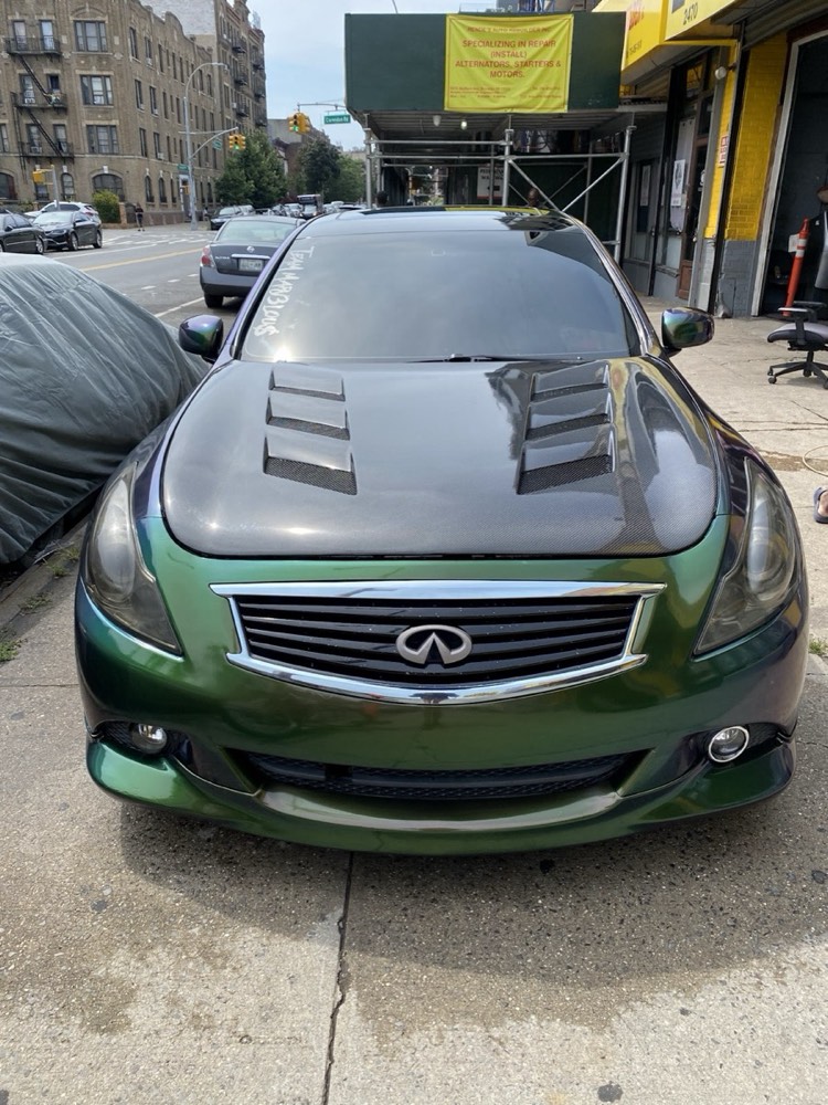 Infiniti G37 in a green to purple color-shift wrap with carbon hood