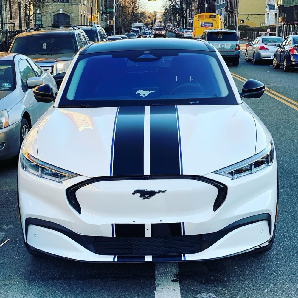 White Ford Mustang Mach-E with black racing stripes