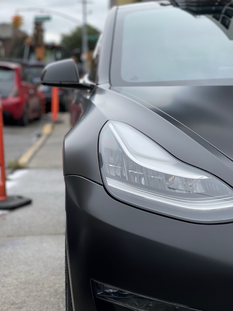 Tesla Model 3 headlight and fender in satin black wrap